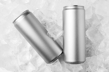 Refreshing drinks in cans on ice cubes, top view