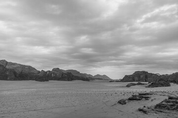 A desolate desert landscape with a cloudy sky