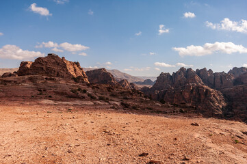 A desert landscape with a mountain in the background