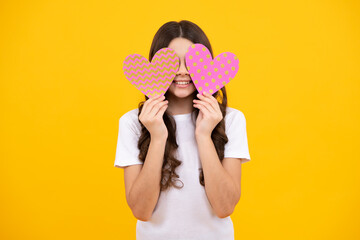Young teenager child girl with heart shape. Happy Valentines Day. Love and pleasant feelings concept. Happy teenager, positive and smiling emotions of teen girl.