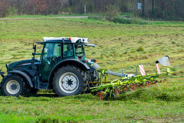 Obraz premium Tractor with Tedder in the Field