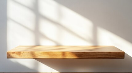 A minimalist wooden shelf casting soft shadows against a light wall, creating a serene and modern ambiance