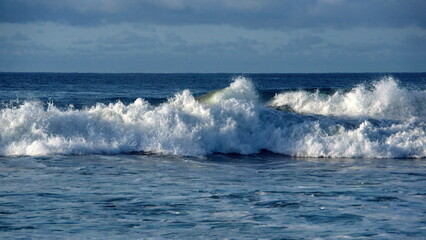 Fototapeta premium Waves breaking just off the beach in Zipolite, Mexico
