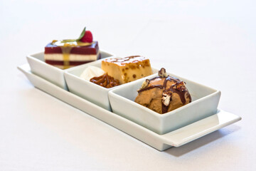 Three delicious desserts: flan with meringue, quince paste, and walnut ice cream with chocolate.