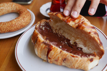 Delicious croissant filled with chocolate served in a cozy cafe