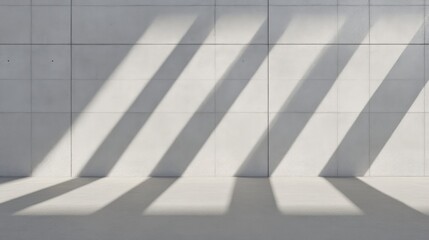 Obraz premium Sunlight casts long, parallel shadows on a light gray concrete wall and floor
