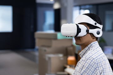 Man using VR headset in modern office, exploring virtual reality technology, copy space