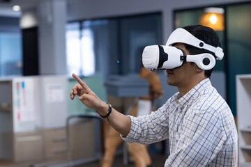 Man using VR headset in modern office, interacting with virtual environment