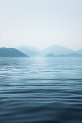 Calm body of water with mountains in the background