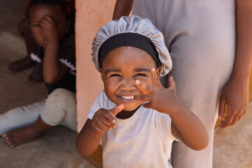 african village, portrait of two smiling african children, playing in front of the house , south africa township © poco_bw