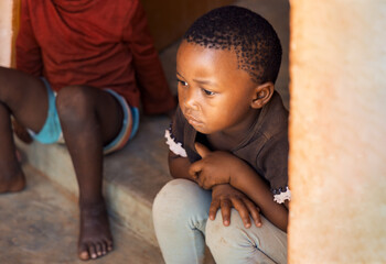 african village, portrait of african child, thinking facial expression playing in front of the house , south africa township © poco_bw
