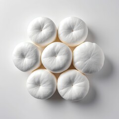Six White Puffy Objects Arranged in a Circular Pattern