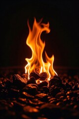 flames are lit in the dark on a rocky surface