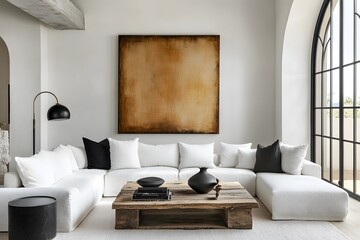 Grunge old accent coffee table near white sofa against arched window and white wall with big art poster frame. Minimalist, art deco interior design of modern living room, home. 2025
