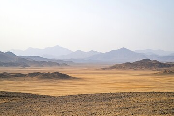 Fototapeta premium A scenic vista of rolling hills and distant mountain range