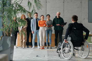 Multiethnic Business Team Collaborating in a Modern Office with Director in a Wheelchair