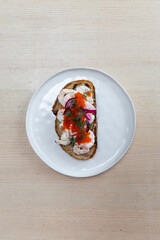 A plate of prawn toast on sourdough bread.