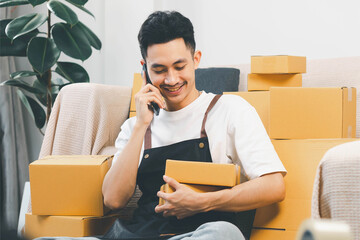 Startup small business, man working freelance and packing box delivery products to customers, Ordered online. packing boxes for online orders ready for shipping, Pack products box delivery products.