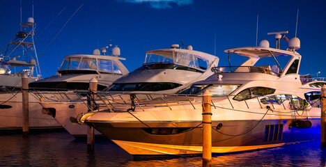Fototapeta premium Yacht sailing on sea waters. Luxury superyacht at sea. Miami Beach with yachts. Tropical seascape with a sailboat. Cruise ship near the coastline. Sunset yacht voyage in Florida. Luxury yacht.