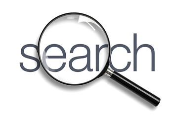 A magnifying glass hovering over the word search on a white background