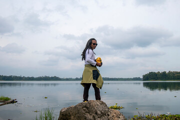 People enjoy the beauty of Lake Karangkates, Indonesia. Model is posing while being photographed