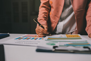 Cropped image of professional businesswoman working at her office via laptop, young female manager using portable computer device while sitting at modern loft, flare light, work process concept