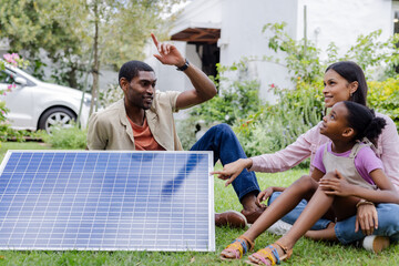 Family enjoying outdoor time discussing solar panel benefits in garden