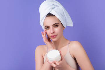 Beauty portrait of a beautiful woman applying face cream. Woman applying moisturizing skincare...