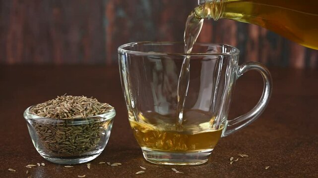 Jeera water also called as cumin water is served in a cup.