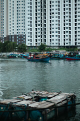 Obraz premium Boats Docked Near Modern High-Rise Building