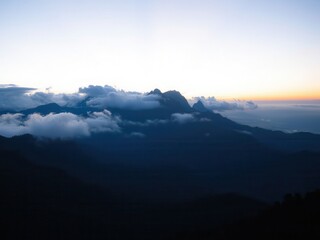 Fototapeta premium Sunrise over Cloud Covered Mountains