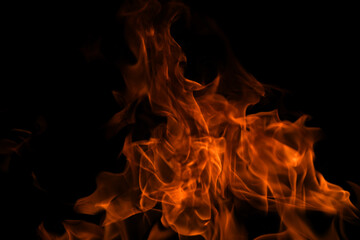 Fototapeta premium Fire flames isolated on black background. Fire burn flame isolated, flaming burning art design concept with space for text.