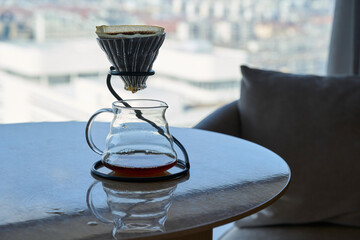 filtered coffeepot on table beside cozy sofa