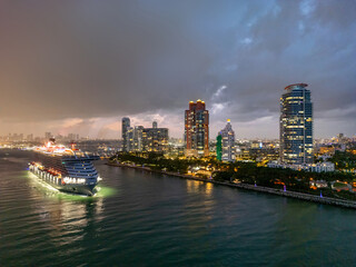 Cityscape of downtown Miami at night light. Famous Florida resorts and beaches. Midnight city lights in Miami. Waterfront view of Miami. Aerial shot of Miami at sunrise. Neon Art Deco. Ocean drive.