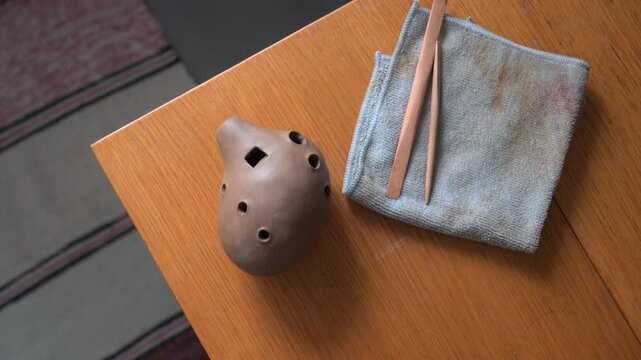 Handcrafted Ocarina Artistically Created with Essential Tools on a Beautiful Wooden Table
