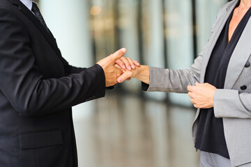 Scene of empathy between businessman and businesswoman with hold hand focus with formal suit.