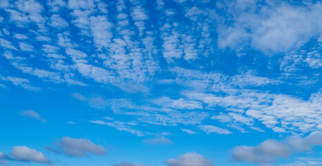 Background with clouds on blue sky. Sky view. Beautiful sunny sky. Clouds on blue sky. Sun shining...