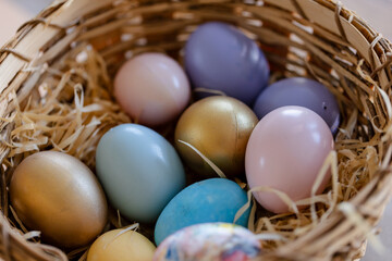 Colorful Easter eggs in wicker basket, celebrating holiday with festive decorations