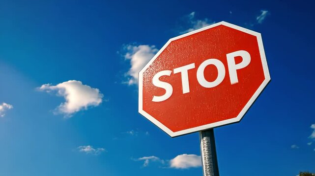 Block Symbol Indicator, Vibrant red stop sign against a clear blue sky with clouds