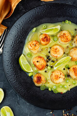Scallops with a basil creamy sauce.