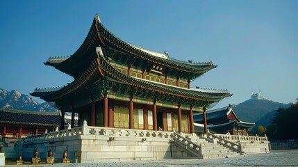Obraz premium Traditional Asian architecture of a historic palace with mountains in the background, serene setting