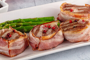 Tasty grilled pork medallion with bacon