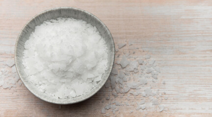 Magnesium flakes in a bowl on wooden table