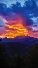Vibrant sunset over purple mountain range.