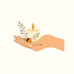 Gentle hand holding candle with eucalyptus and acorn, organic warmth