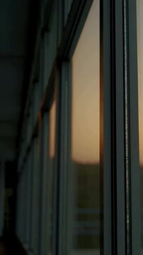 Sunset reflections on glass windows in urban architecture
