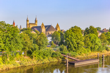 Obraz premium Towers of the OLV church at the Maas riverbank in Maastricht, Netherlands