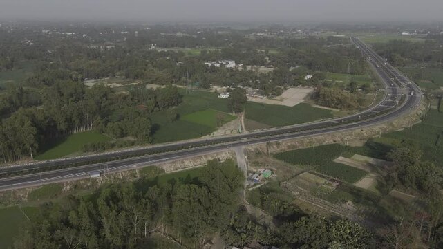 Drone shot video of national highway. 4k Aerial view village Road, Drone view Highway, Countryside Road. Drone shot high angle Aerial view of the road at the village side. Raw footage. India