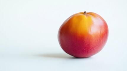 A fresh tamarillo fruit with vibrant red-orange skin, isolated on a white background