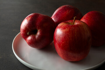 A closeup view of a plate of red gala apples.